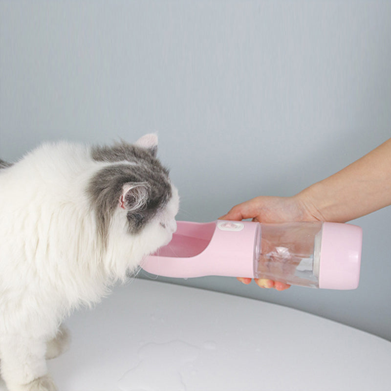 Portable Pet Food & Water Bottle by Teal Winterberry, pink plastic, cat drinking from the nozzle