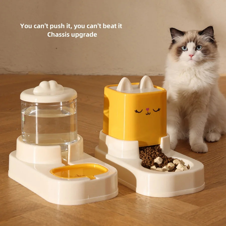 Two-part automatic pet feeder with water dispenser and dry food bowl; white base, yellow food module, cat nearby