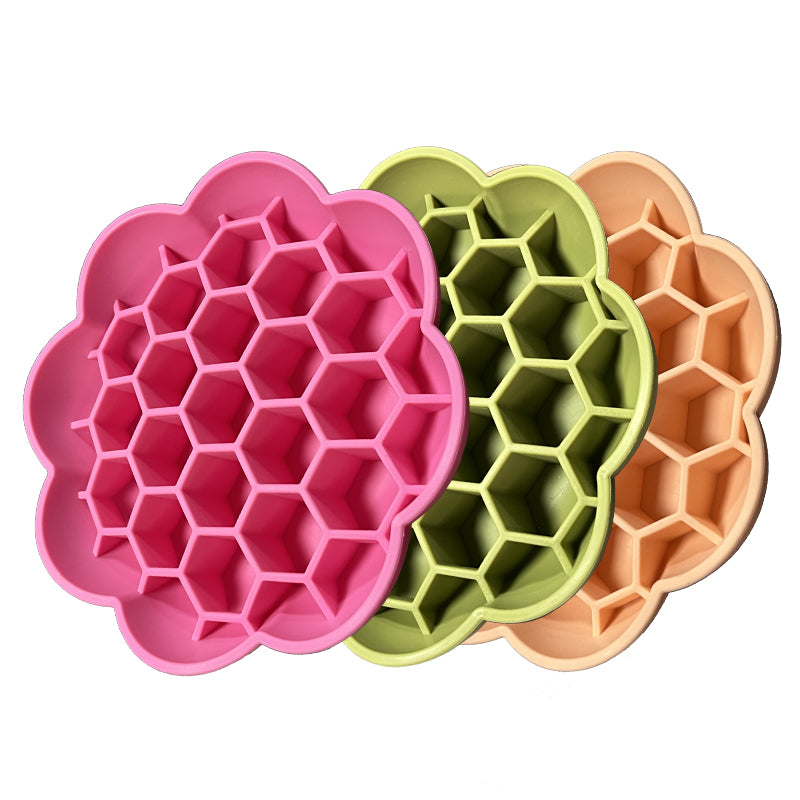 Flower-shaped silicone dog slow feeder bowls set of 3 in pink, green and peach.