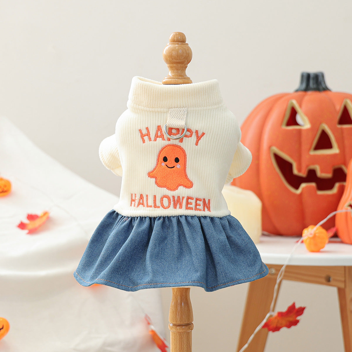 Pet Halloween ghost dress for small dogs and cats, white knit top with orange ghost and blue denim skirt.